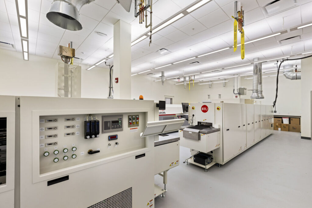 A bright white laboratory has seamless, durable flooring designed for easy cleaning and hygienic safety.