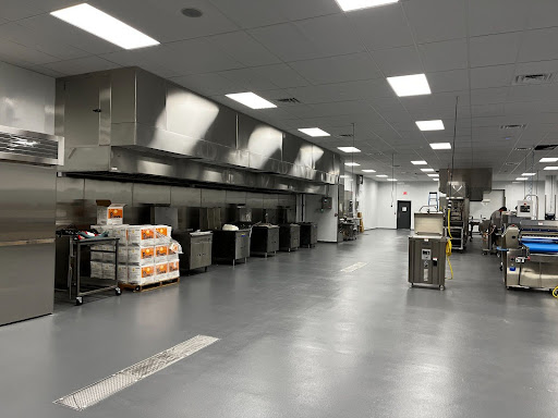 A large commercial kitchen has FDA-compliant floors for a clean and safe environment.