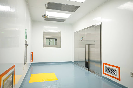 A commercial space with a hygienic seamless flooring system features cove base transitions between floor and wall for contamination control.